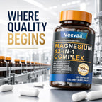 A bottle of Vccvaa Magnesium 12-in-1 Complex dietary supplement capsules, shown in a clean, modern industrial setting with white capsules scattered in the foreground and a blurred background of more bottles.